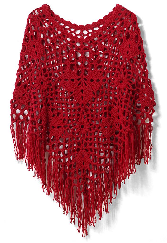 Front view of a delicate hand-knit fringe cape in vibrant red, featuring intricate crochet patterns and long, flowing fringes for a bohemian vibe.