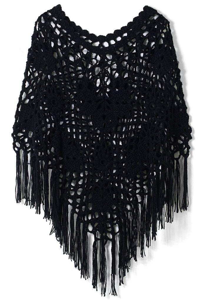 Front view of a black hand-knit cape with intricate crochet patterns and long fringe detailing, exuding a vintage-inspired and elegant vibe.