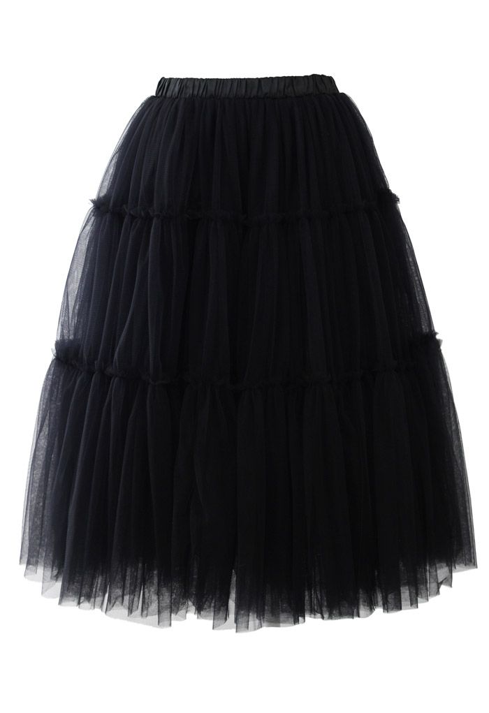 Front view of a romantic black tulle midi skirt with layered design, creating a voluminous and elegant silhouette.