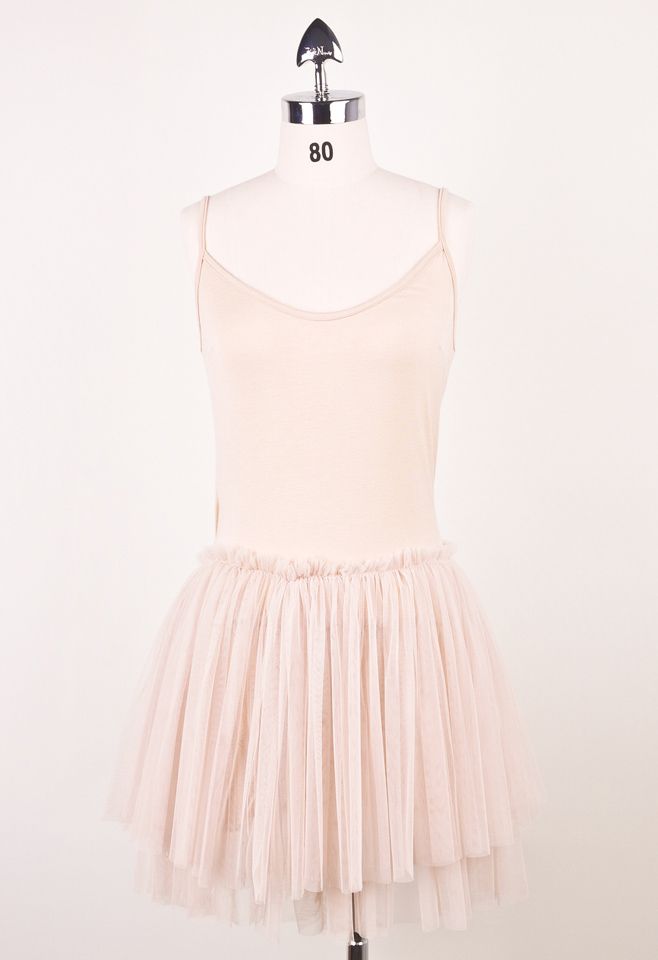 Front view of a romantic ballet tulle dress featuring a fitted bodice with thin straps and a voluminous layered tulle skirt in soft pink.