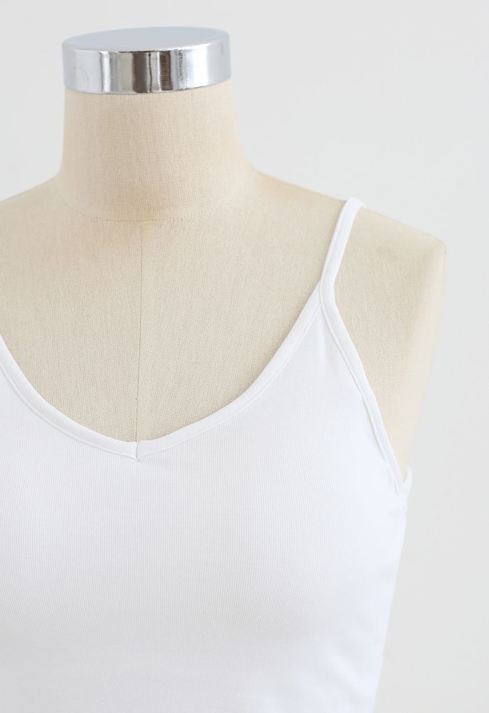 Front view of a white cropped rib cami tank top on a mannequin, showcasing a simple and minimalist design.