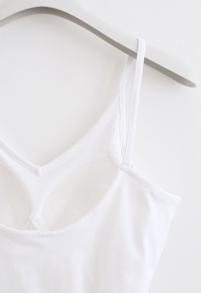 White cropped rib cami tank top on a hanger, showing the back design with a scoop neckline.