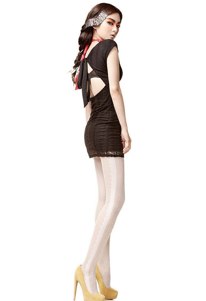 Side view of a model in French romantic tights with a black dress, showcasing the lace detailing and stylish design.