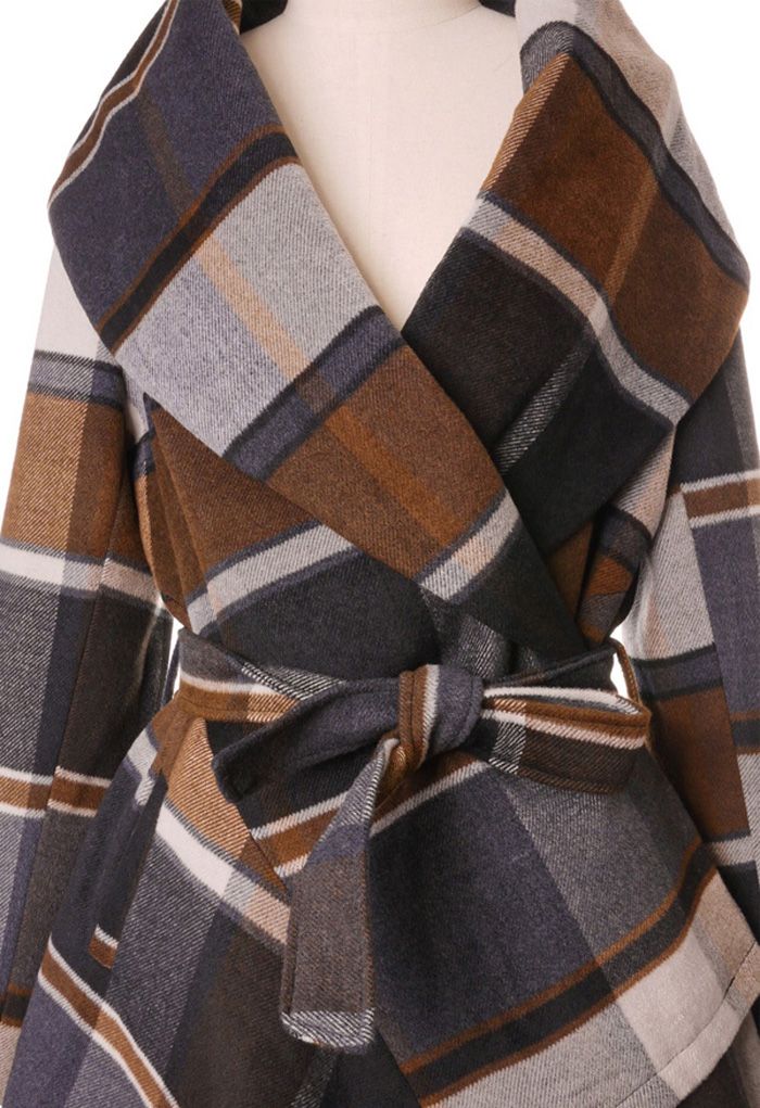 Close-up detail shot of the Prairie Check Rabato Coat, highlighting the large plaid pattern and belted waist in warm brown and grey tones.