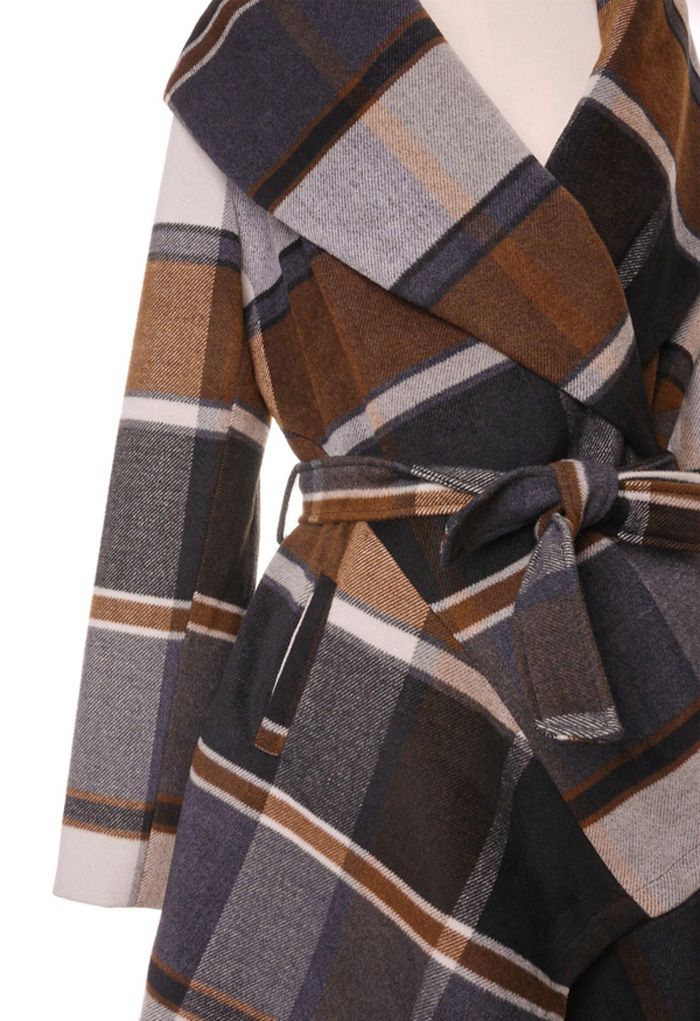 Detail shot of the Prairie Check Rabato Coat, showcasing the plaid pattern and belted waist with a focus on the sleeve and side.