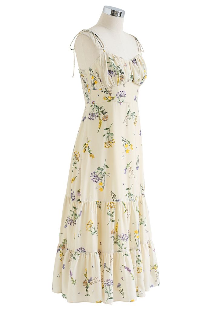 Side view of the dress on a mannequin, featuring a flowing skirt and floral design.