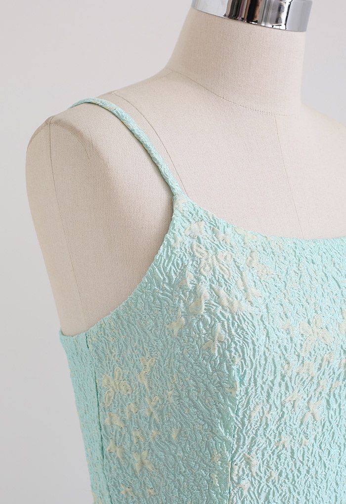 Detail shot of the shoulder strap and upper section of the blue cami midi dress, featuring butterfly embroidery.