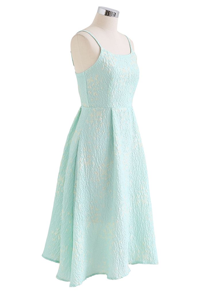 Side view of the blue cami midi dress on a mannequin, showing the fitted bodice and flared skirt.
