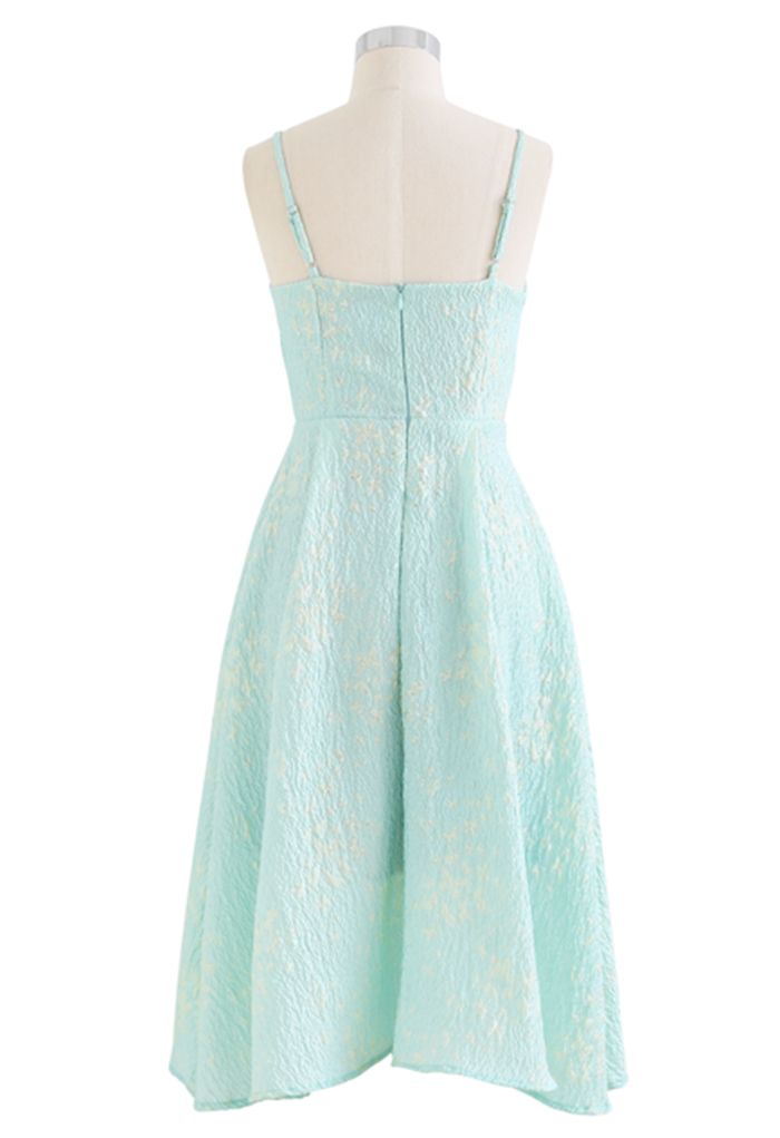 Back view of the blue cami midi dress on a mannequin, highlighting the butterfly embroidery and embossed texture.