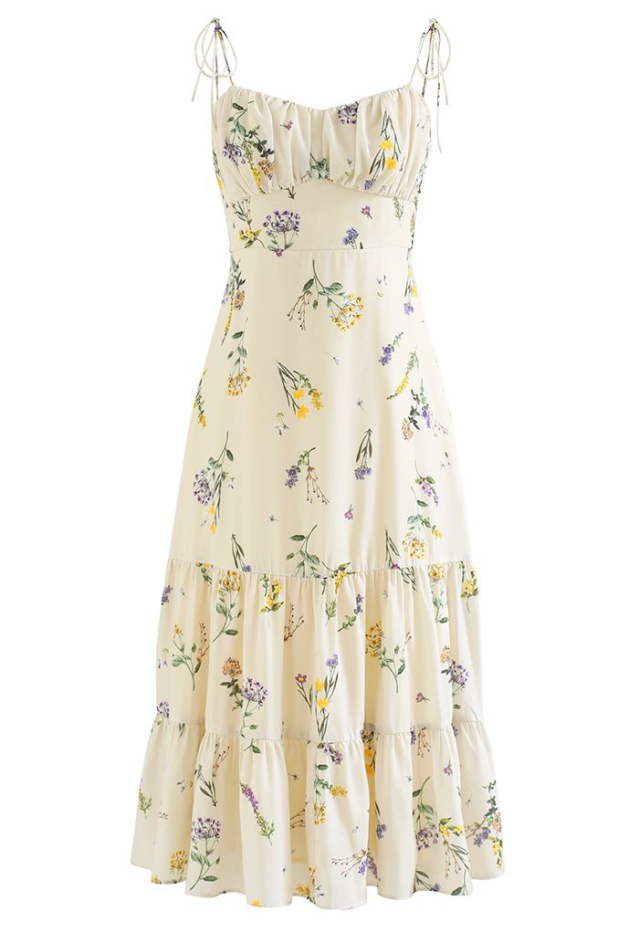 Front view of a romantic midi dress featuring a wild flowers print and tie straps.