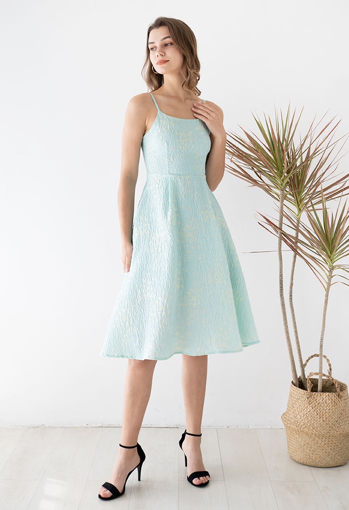 Model posing in the blue cami midi dress with butterfly embroidery, creating a chic and elegant look.