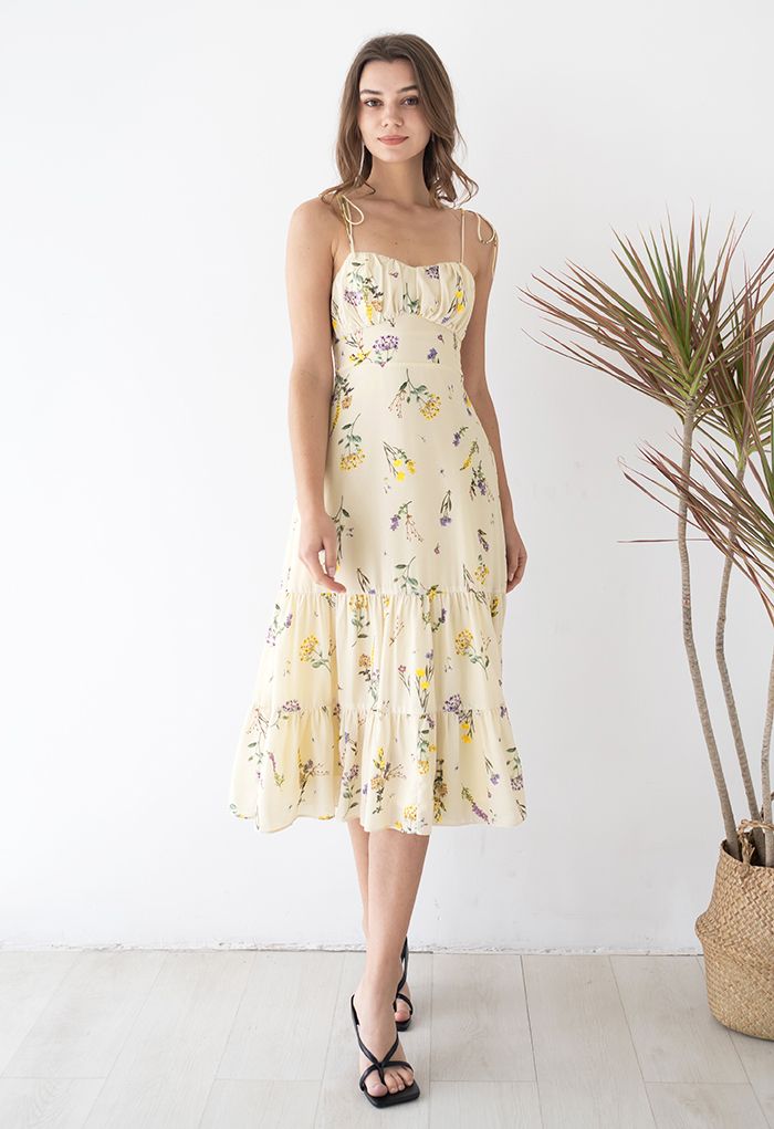 Model standing in the dress, displaying the elegant floral design and tie straps.