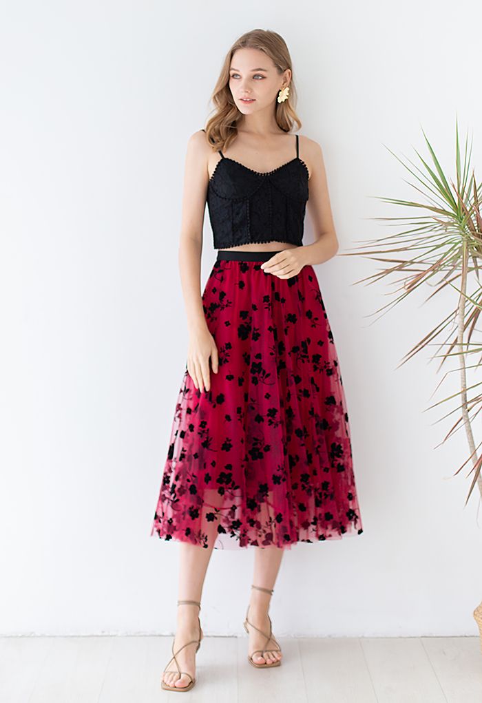 Outfit shot featuring a model in a red 3D posy mesh skirt paired with a black lace top, creating a chic and elegant look.