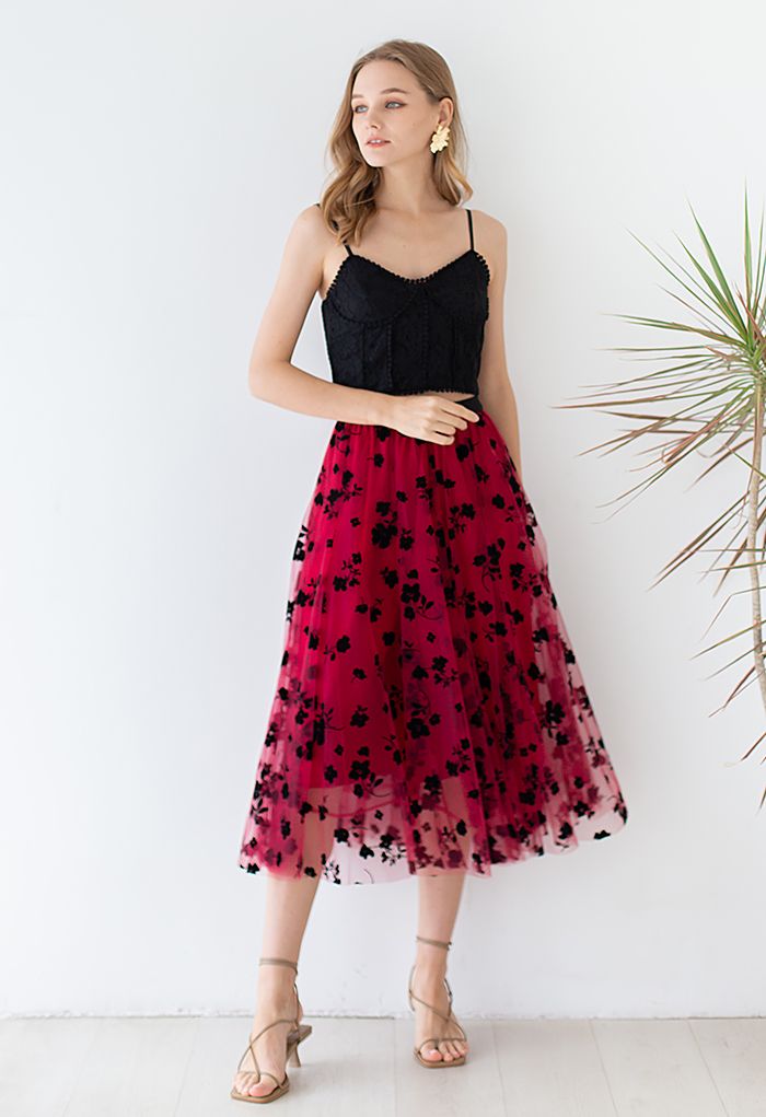 Outfit shot of a model wearing a red 3D posy mesh skirt with a black lace top, exuding a sophisticated and stylish vibe.