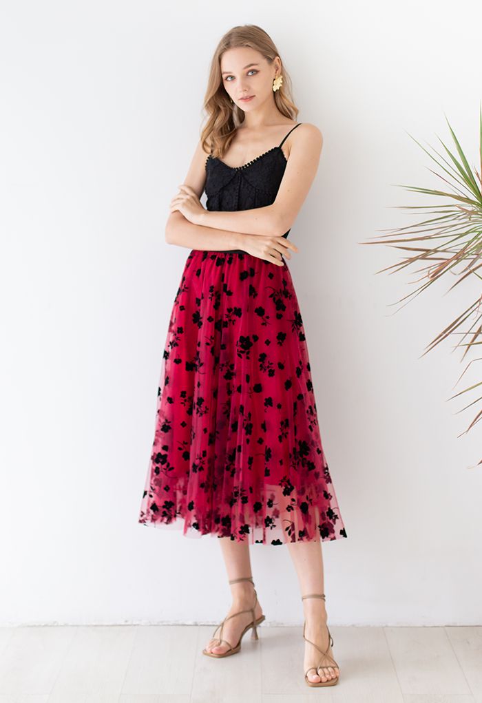 Outfit shot of a model in a red 3D posy mesh skirt and black lace top, showcasing a chic and elegant style.