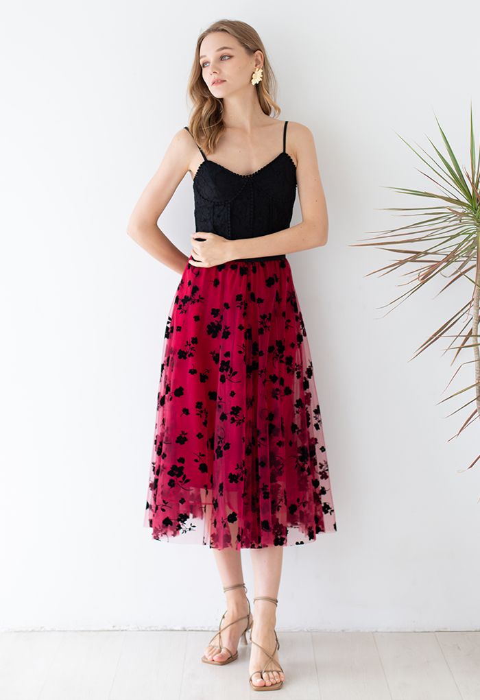 Outfit shot of a model in a red 3D posy mesh skirt paired with a black lace top, creating a stylish and romantic look.