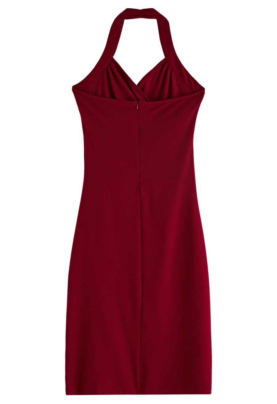 Back view of a burgundy halter neck dress, showcasing its sleek and fitted design.