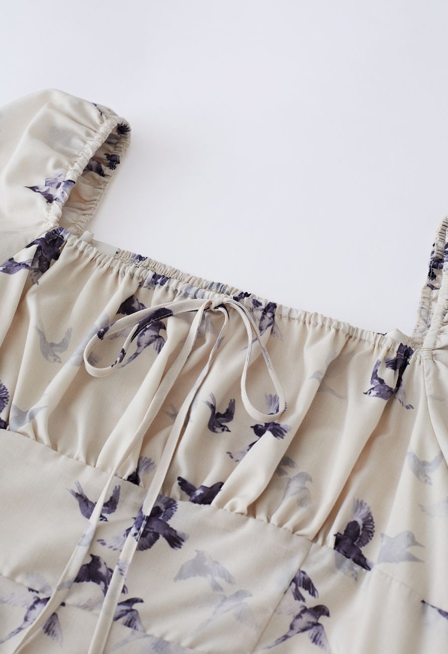 Detail shot of the seagull print square neck midi dress, highlighting the tie and shirring at the neckline.