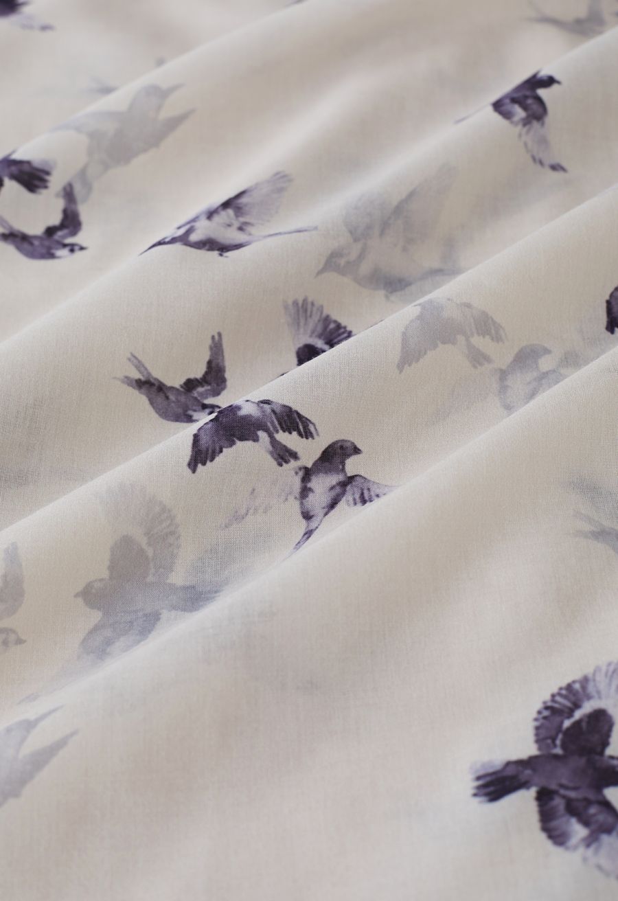 Detailed view of the flowing fabric with seagull print on the midi dress, highlighting the soft texture.