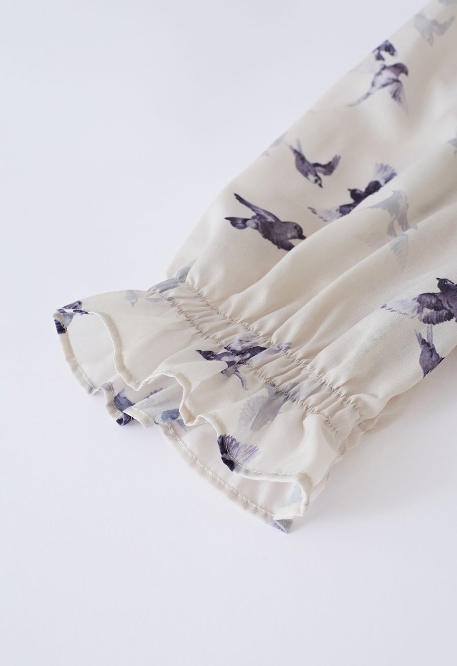 Close-up of the puff sleeve with ruffle detail on the seagull print midi dress.