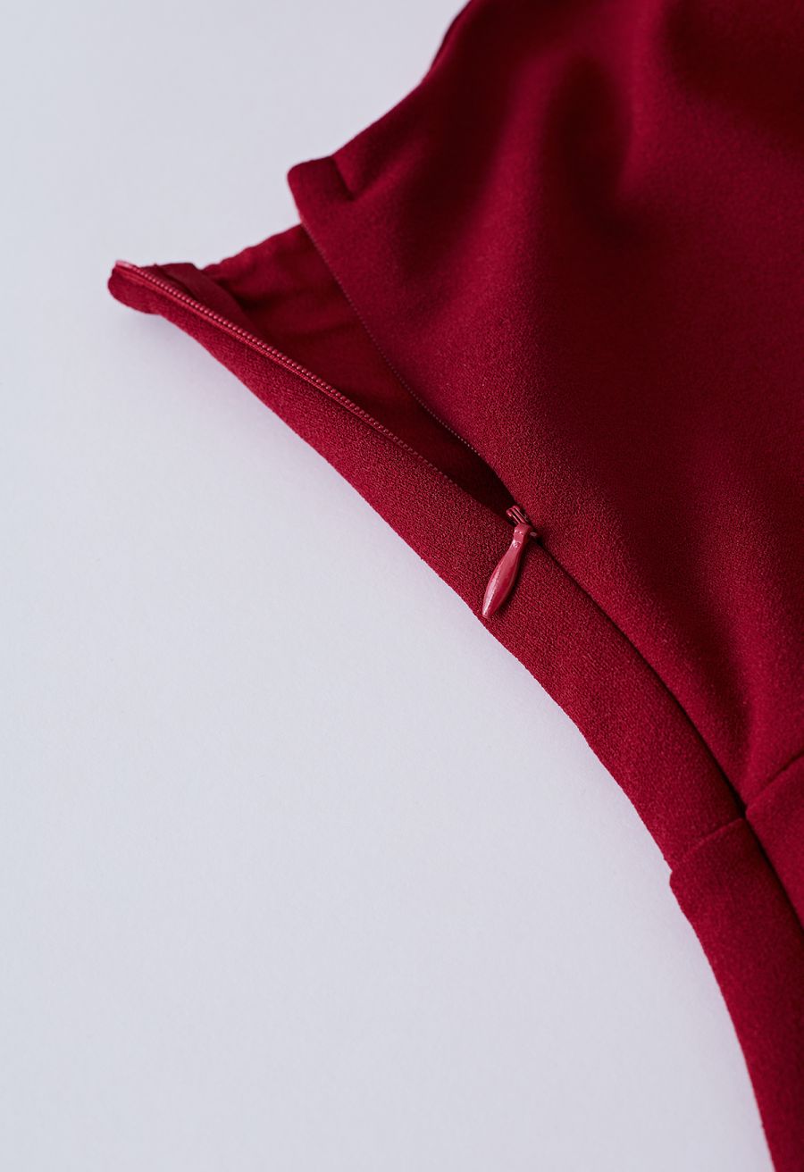 Detail shot of a burgundy dress zipper, highlighting the sleek and functional design.