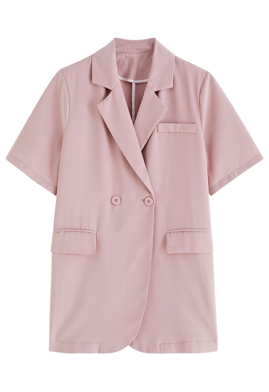 Front view of a classic notch lapel short-sleeve blazer in a soft pink hue, featuring a sleek and modern design.