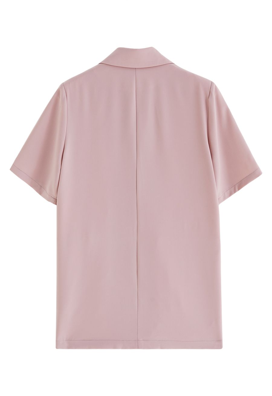 Back view of a classic pink short-sleeve blazer with a notch lapel, showcasing a simple and elegant design.