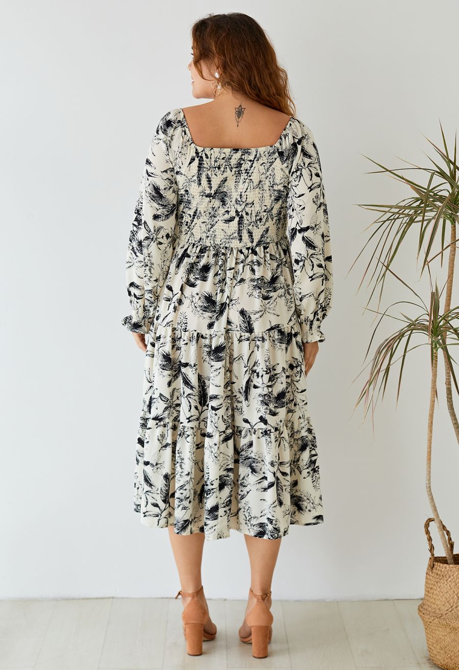 Back view of the inky botanical print square neck midi dress, showcasing the flowy skirt and smocked bodice.
