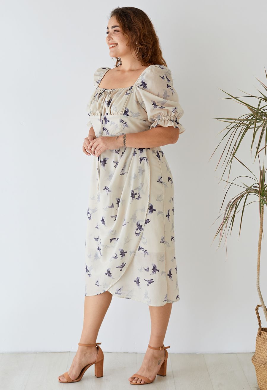 Side view of a woman in the seagull print square neck midi dress, emphasizing the flattering silhouette.