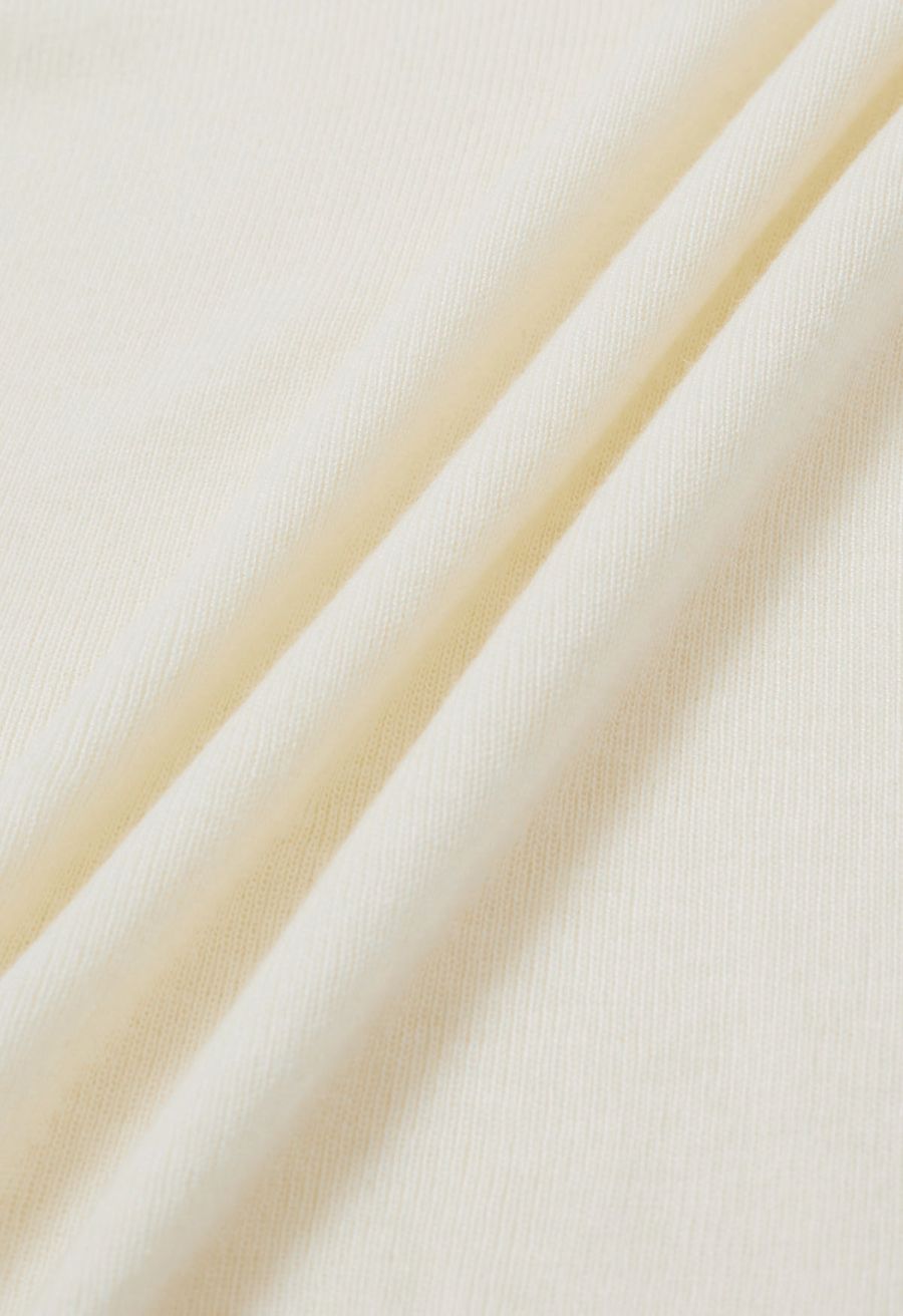 Side Pleat High Neck Ribbed Knit Top in Cream