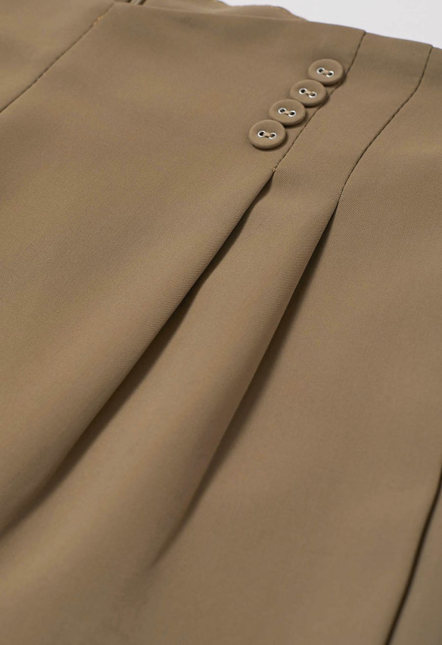 Button-Embellished Dipped Front Waist Shorts in Brown