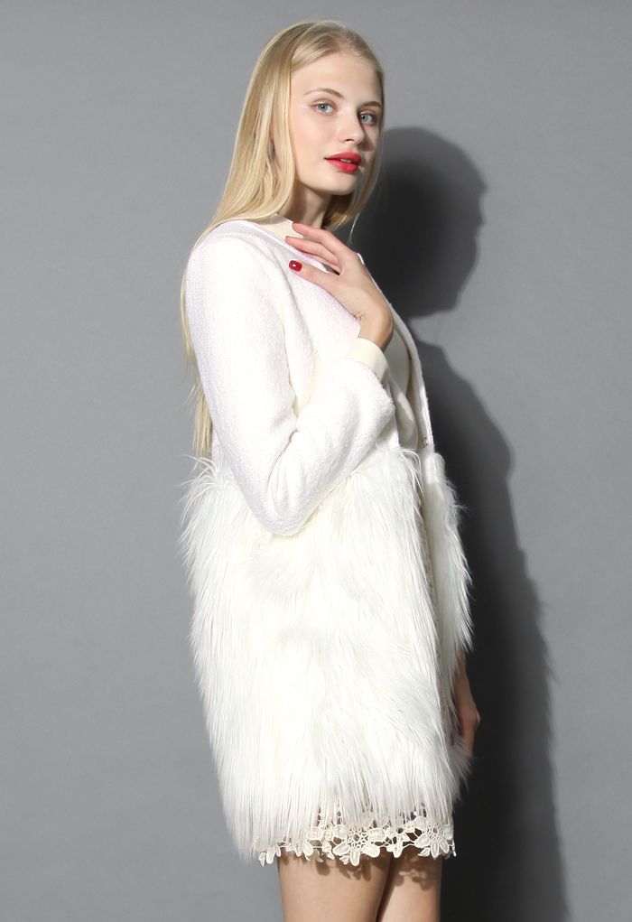 Side view of a woman in a chic winter essential faux fur coat, showcasing its elegant white texture and stylish fur trim.