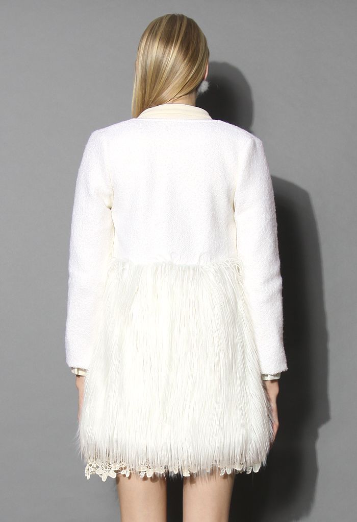 Back view of a chic winter essential faux fur coat, highlighting its textured white fabric and luxurious fur trim.