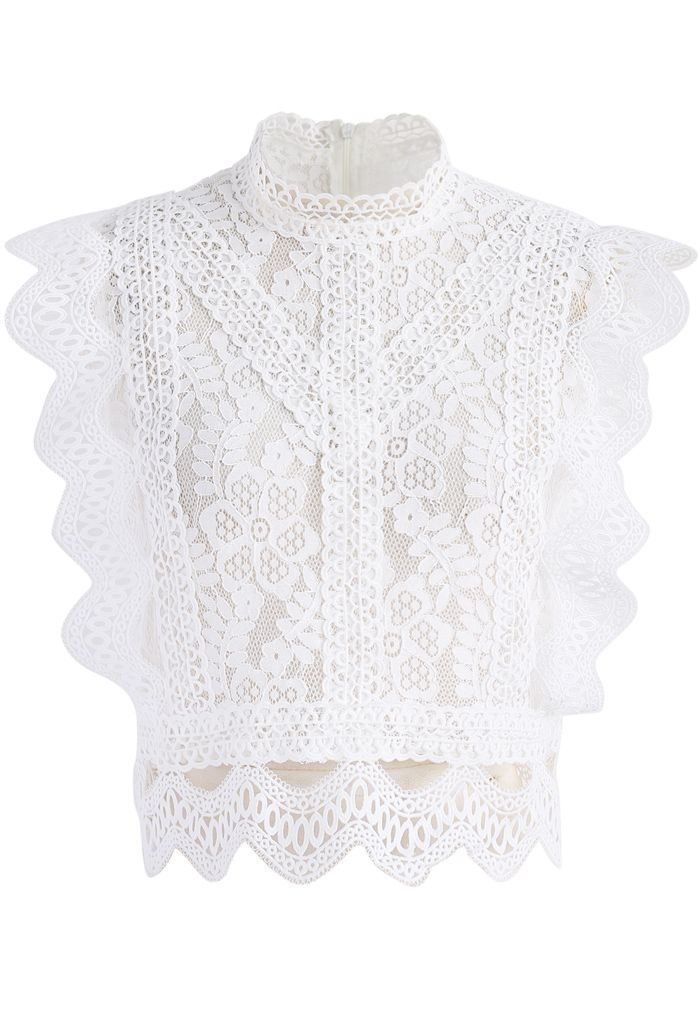 Front view of a romantic sleeveless white crochet lace top with intricate floral patterns and scalloped edges.