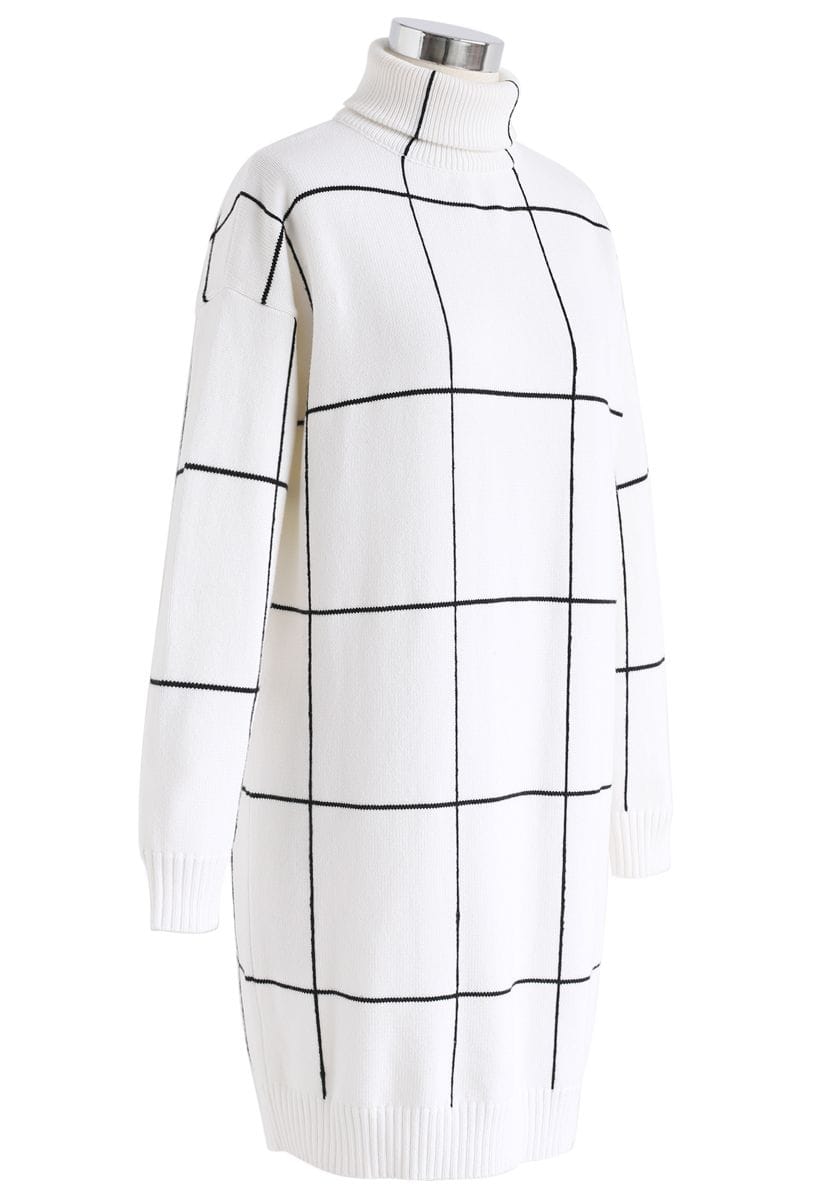 Side view of a white turtleneck sweater dress with a black grid pattern, presenting a stylish and contemporary look.