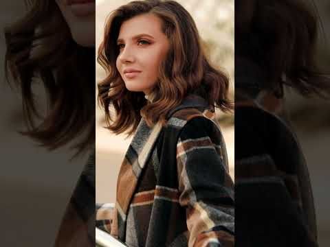 Side view of a woman wearing the Prairie Check Rabato Coat, highlighting the cozy plaid pattern in shades of brown and grey.